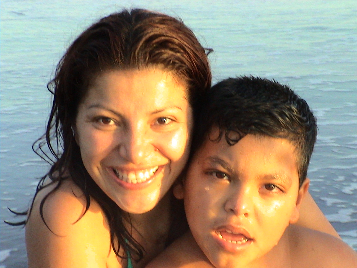 Raul as a child with his mom Debbie at the beach